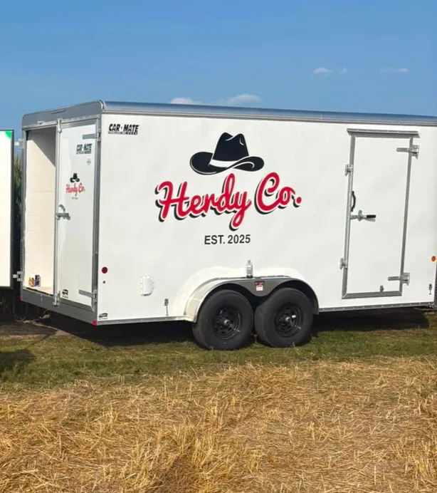 The Herdy Co. refrigerated delivery trailer parked in a field